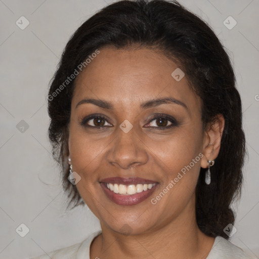 Joyful black adult female with medium  brown hair and brown eyes