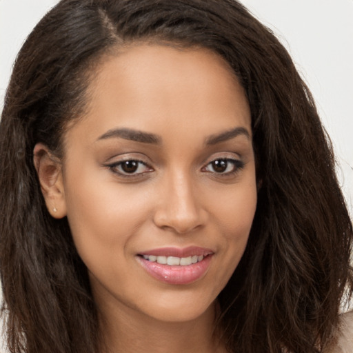 Joyful white young-adult female with long  brown hair and brown eyes