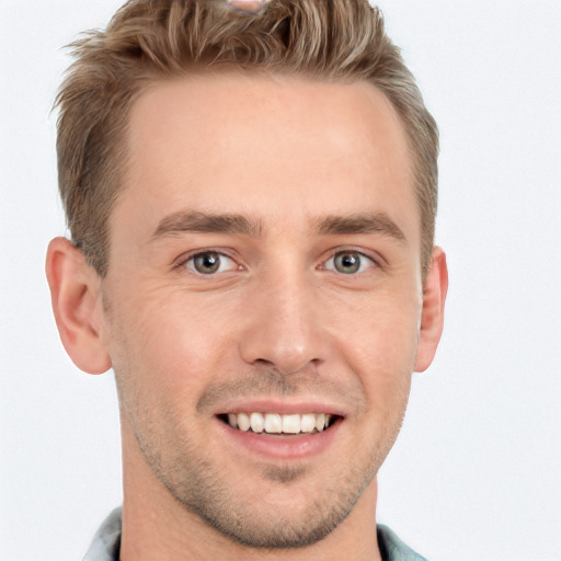 Joyful white young-adult male with short  brown hair and grey eyes