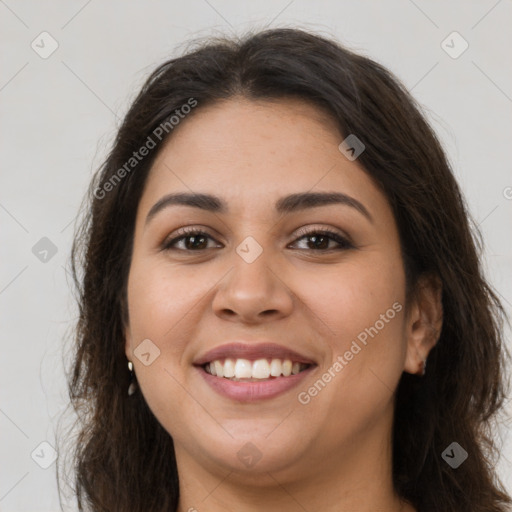 Joyful latino young-adult female with long  brown hair and brown eyes