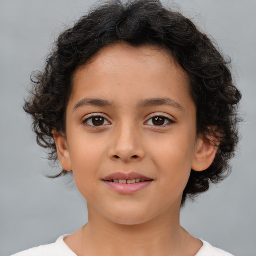 Joyful latino child female with medium  brown hair and brown eyes