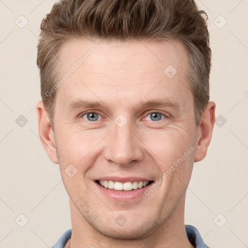 Joyful white adult male with short  brown hair and grey eyes