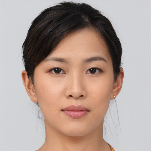 Joyful asian young-adult female with short  brown hair and brown eyes