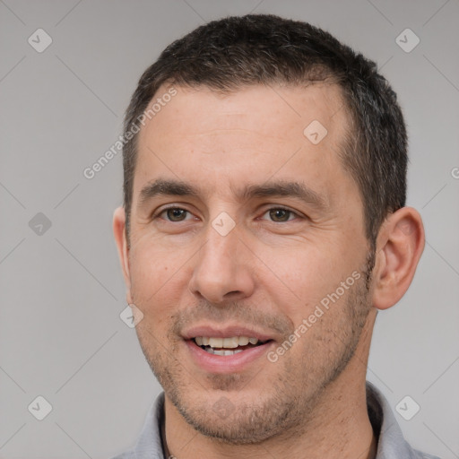 Joyful white young-adult male with short  black hair and brown eyes