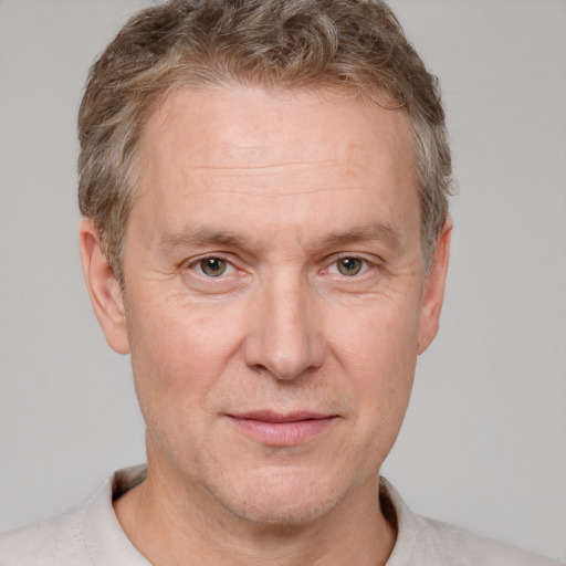 Joyful white adult male with short  brown hair and grey eyes