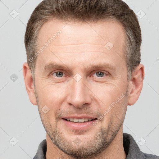 Joyful white adult male with short  brown hair and grey eyes