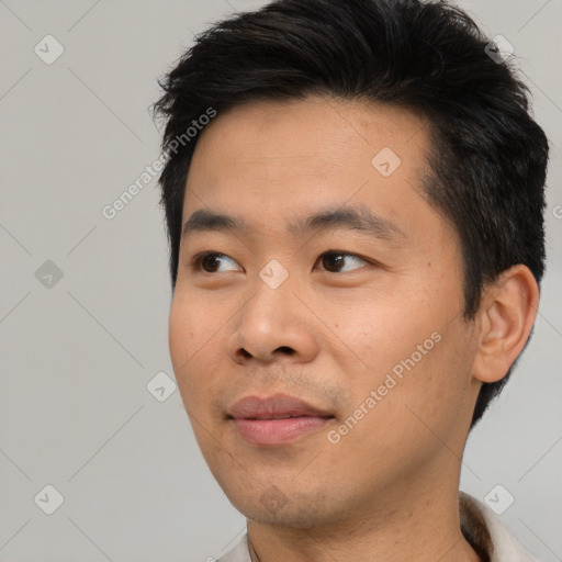 Joyful asian young-adult male with short  black hair and brown eyes