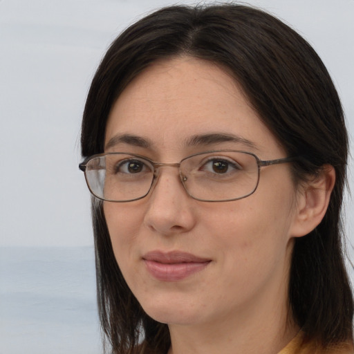 Joyful white adult female with long  brown hair and brown eyes