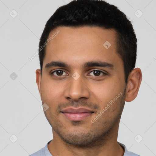 Joyful latino young-adult male with short  black hair and brown eyes