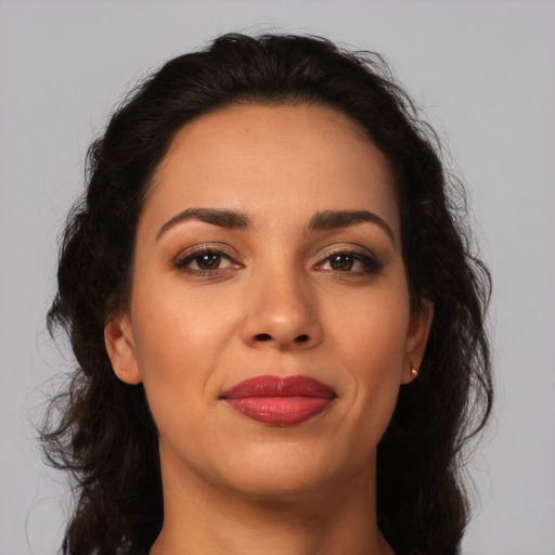 Joyful latino young-adult female with medium  brown hair and brown eyes