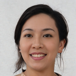 Joyful asian young-adult female with medium  black hair and brown eyes