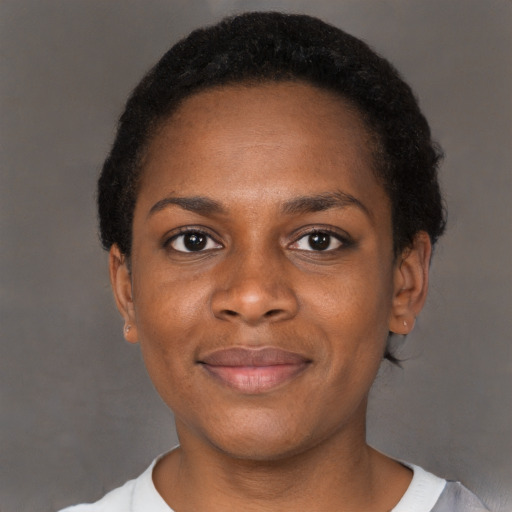 Joyful black young-adult female with short  brown hair and brown eyes
