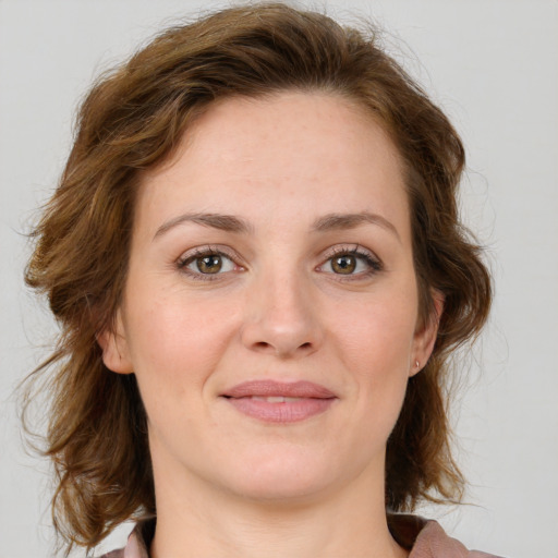 Joyful white young-adult female with medium  brown hair and green eyes