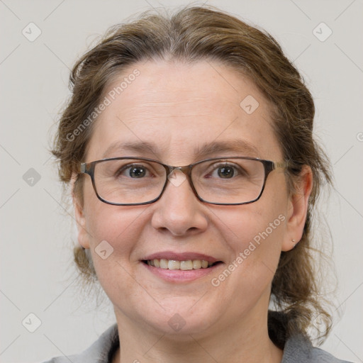 Joyful white adult female with medium  brown hair and grey eyes