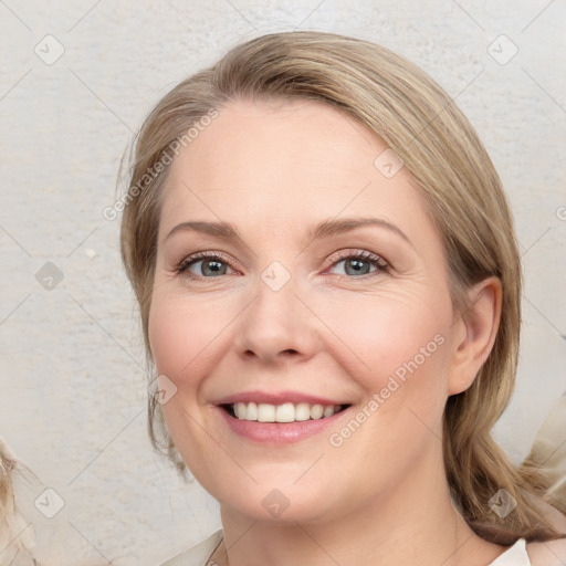 Joyful white young-adult female with medium  brown hair and blue eyes