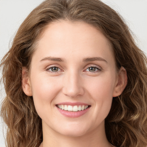 Joyful white young-adult female with long  brown hair and green eyes