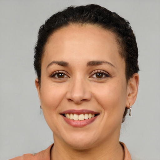 Joyful latino young-adult female with short  brown hair and brown eyes