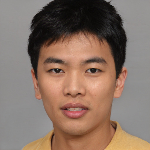 Joyful asian young-adult male with short  black hair and brown eyes