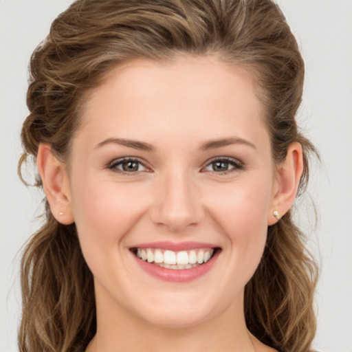 Joyful white young-adult female with long  brown hair and green eyes