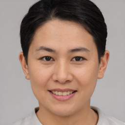 Joyful asian young-adult female with short  brown hair and brown eyes