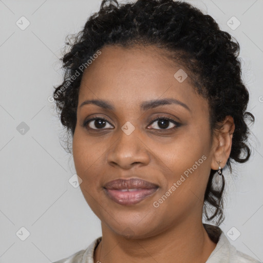 Joyful black young-adult female with medium  brown hair and brown eyes