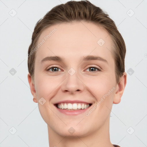 Joyful white young-adult female with short  brown hair and grey eyes