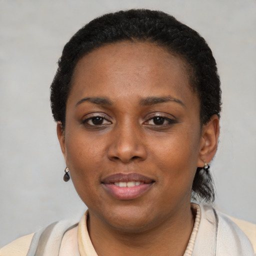 Joyful latino young-adult female with short  black hair and brown eyes