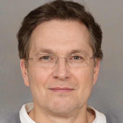 Joyful white adult male with short  brown hair and grey eyes