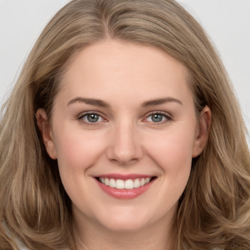 Joyful white young-adult female with long  brown hair and grey eyes