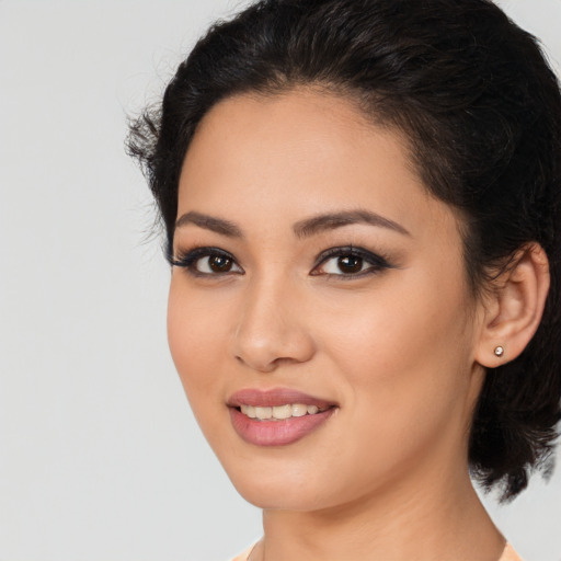 Joyful latino young-adult female with medium  black hair and brown eyes