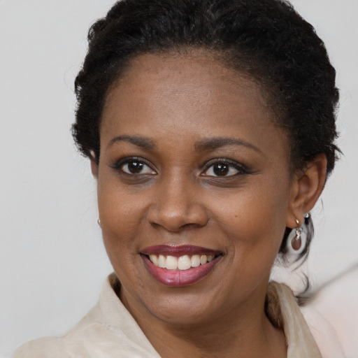 Joyful black young-adult female with medium  brown hair and brown eyes