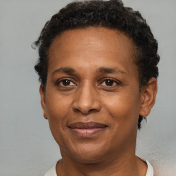 Joyful black adult female with short  brown hair and brown eyes
