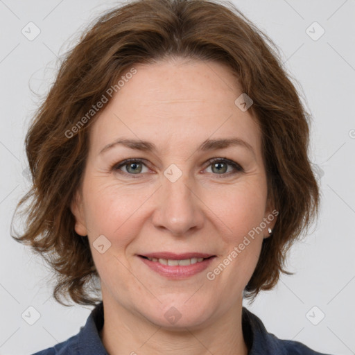 Joyful white adult female with medium  brown hair and grey eyes