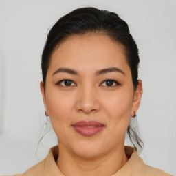 Joyful latino young-adult female with medium  brown hair and brown eyes