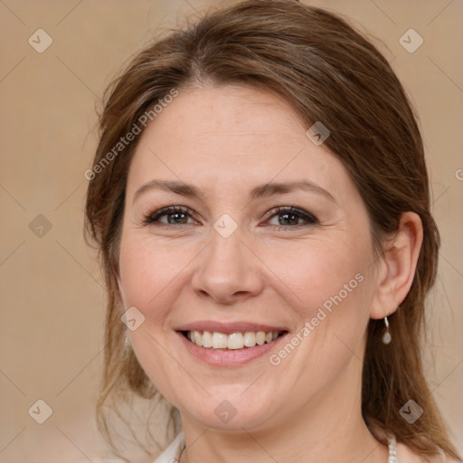 Joyful white adult female with medium  brown hair and brown eyes