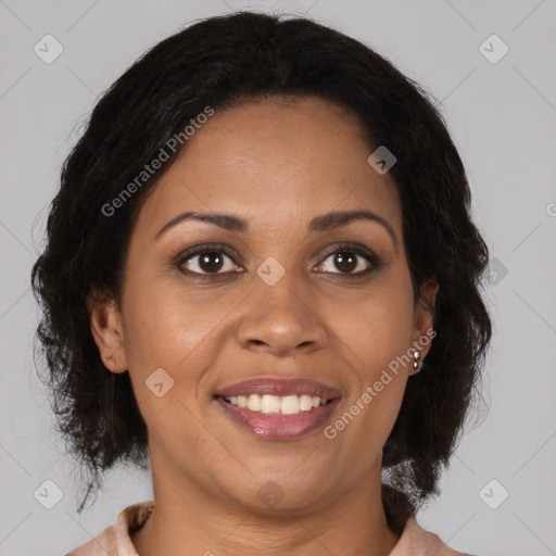 Joyful black adult female with medium  brown hair and brown eyes