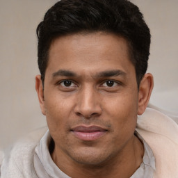 Joyful latino young-adult male with short  brown hair and brown eyes