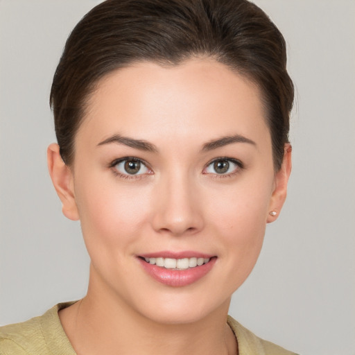 Joyful white young-adult female with short  brown hair and brown eyes