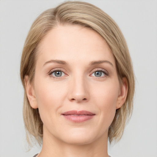 Joyful white young-adult female with medium  brown hair and blue eyes