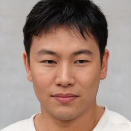 Joyful asian young-adult male with short  brown hair and brown eyes