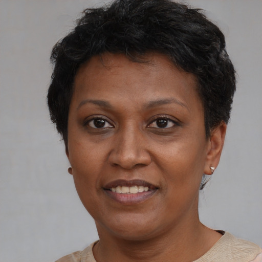 Joyful black adult female with short  brown hair and brown eyes