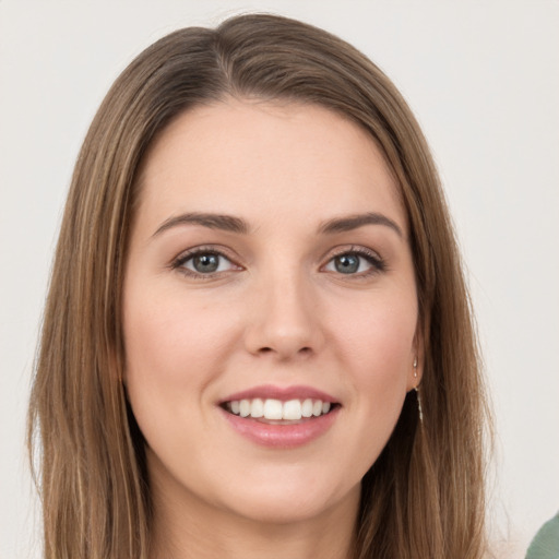 Joyful white young-adult female with long  brown hair and green eyes