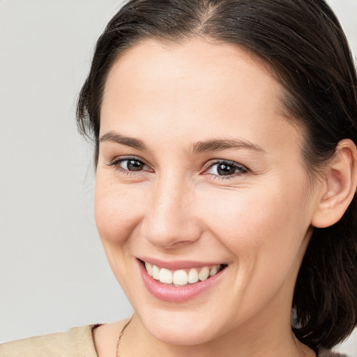 Joyful white young-adult female with medium  brown hair and brown eyes