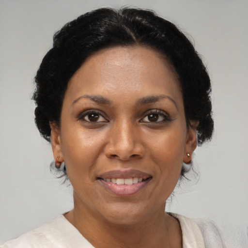 Joyful black adult female with short  black hair and brown eyes