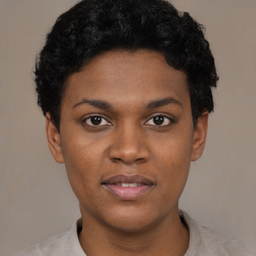 Joyful black young-adult female with short  black hair and brown eyes