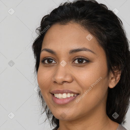 Joyful latino young-adult female with medium  brown hair and brown eyes