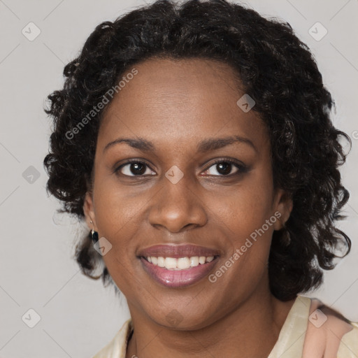 Joyful black young-adult female with short  brown hair and brown eyes