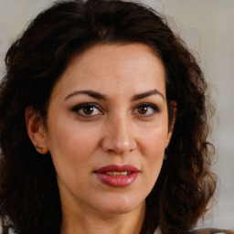 Joyful white adult female with medium  brown hair and brown eyes