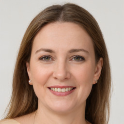 Joyful white young-adult female with medium  brown hair and grey eyes