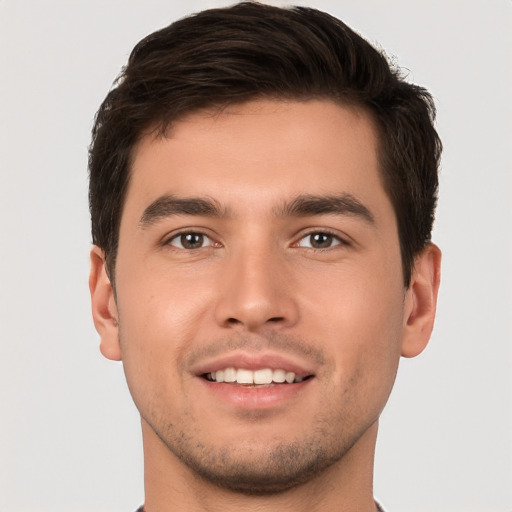 Joyful white young-adult male with short  brown hair and brown eyes